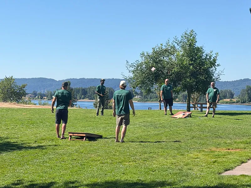 Heritage employees play yard games in the grass.