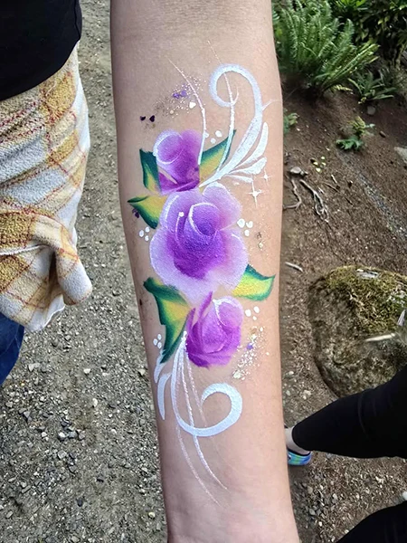 Purple flowers painted on a forearm