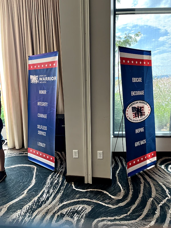 Two AWI banners list these words: Honor, Integrity, Courage, Selfless Service, Loyalty, Educate, Encourage, Inspire, Give Back