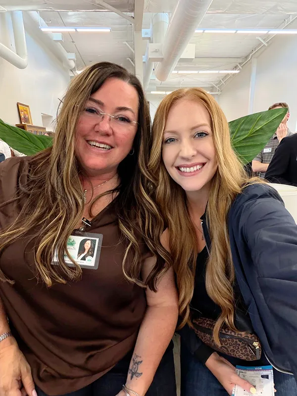 Tara and another person smile for a selfie style photo at the GVC Business After Hours event.