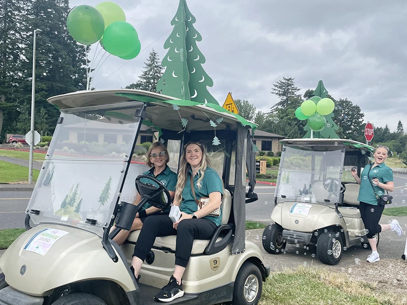 Two decorated Heritage beverage carts, trailing bubbles and offering cocktails on the course.