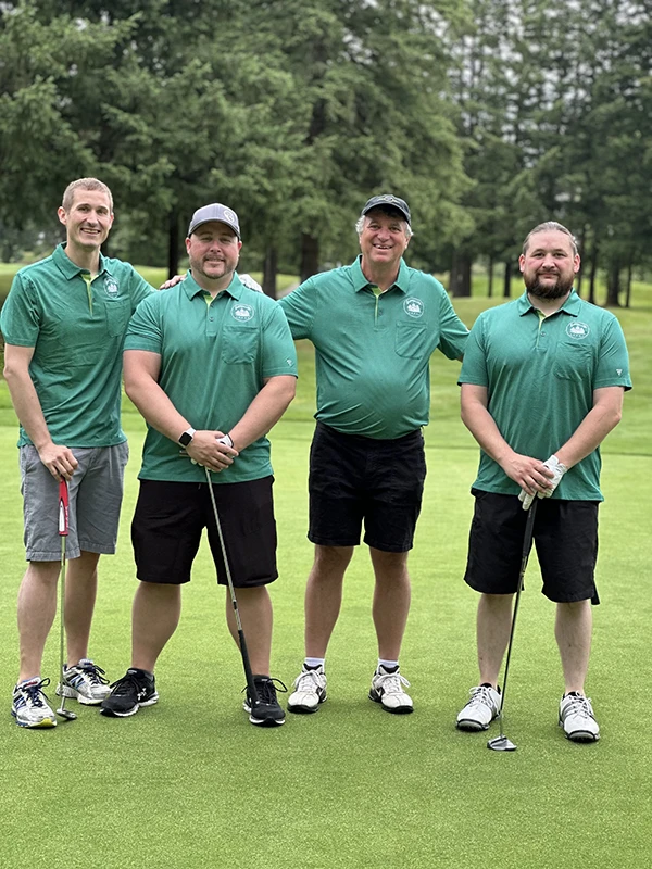 Heritage NW Group golf team stands together on the green